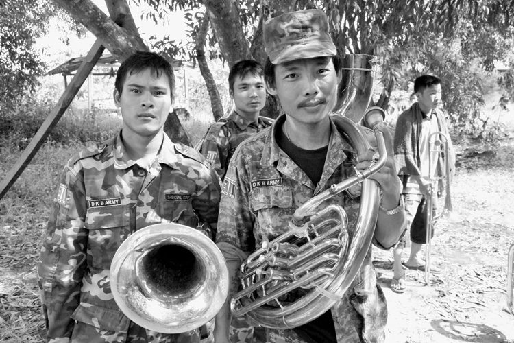 Vier junge Männer in Uniform mit Blechblasinstrumenten.